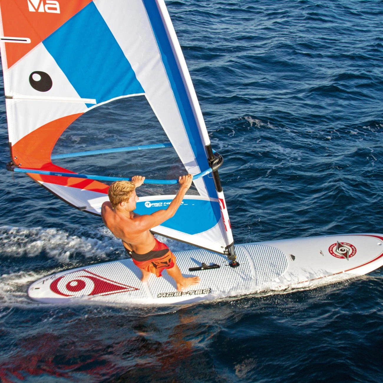 Windsurfer controlling the sail and stance on the board